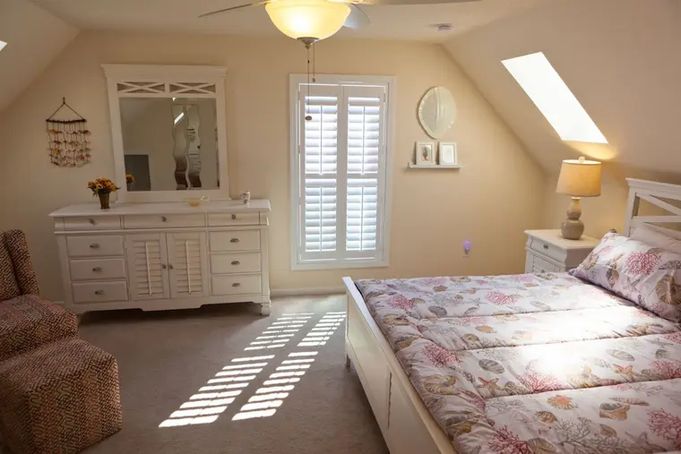 Second bedroom with king bed, dresser, and skylight, Happy Island Cottage