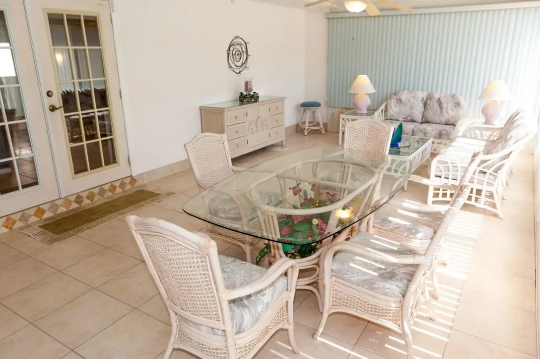 Florida room with white wicker dining set and glass table, Happy Turtle A