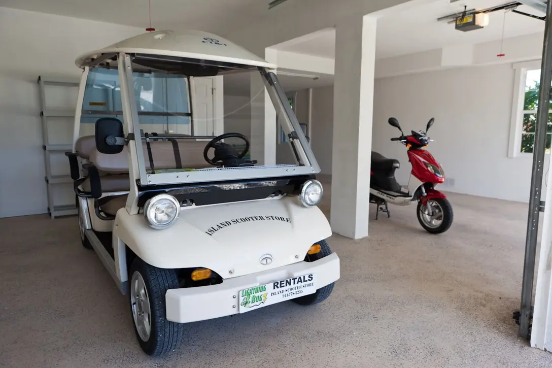 Three-car garage at Happy Island Cottage; golf cart and scooter rentals available across the street
