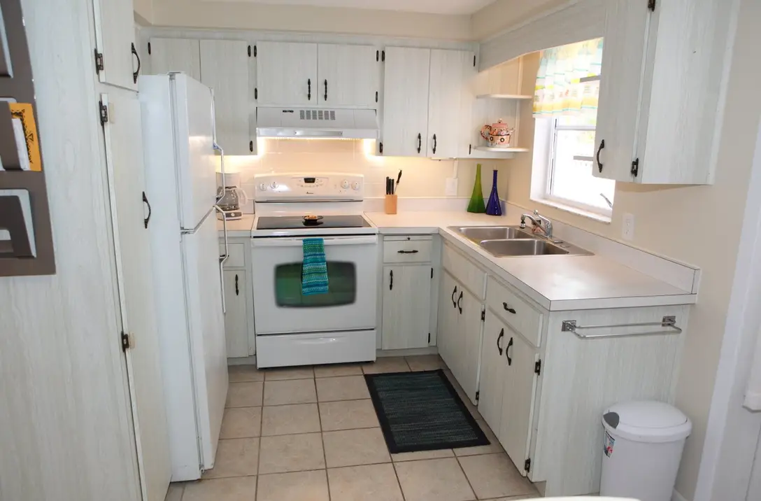Full kitchen with electric range, full-size refrigerator, and window over the sink, Happy Turtle B