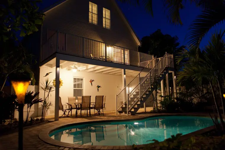 Happy Island Cottage and its private pool lit up at night, Holmes Beach, Anna Maria Island